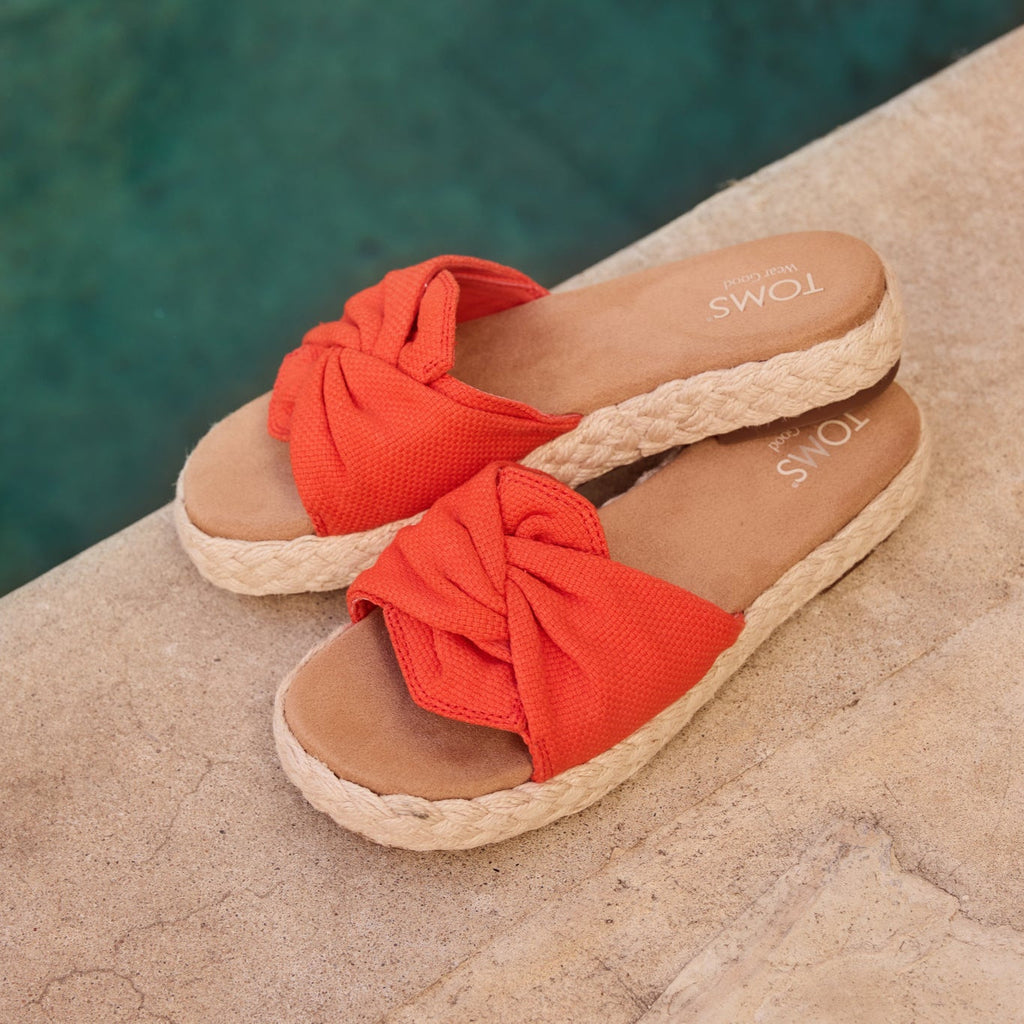Laydown image of the flame woven knot Abby Slide sandal